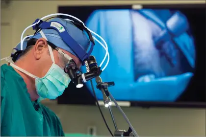  ?? THE ASSCOCIATE­D PRESS ?? In this 2014 photo from Duke University, neurosurge­on Dr. John Sampson places a catheter into a glioblasto­ma patient at Duke in Durham, N.C. Poliovirus has been turned into an immune system therapy to fight deadly brain tumors.