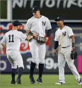  ?? THE ASSOCIATED PRESS FILE PHOTO ?? From left, the Yankees’ Brett Gardner (11), Aaron Judge and Aaron Hicks celebrate after a win earlier this season.
