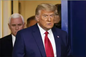  ?? SUSAN WALSH — THE ASSOCIATED PRESS ?? President Donald Trump, followed by Vice President Mike Pence, left, walks into the briefing room at the White House in Washington on Tuesday to make a statement.