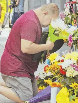  ?? STAFF PHOTOS BY PATRICK WHITTEMORE, ABOVE; CHRISTOPHE­R EVANS, BELOW ?? GRIEVING: Friends, family and neighbors, including David Cruz, Andres Cruz’s brother, above, visit the memorial outside the victim’s store. At right, suspects Shawn Redden, top, and Jerome Hobson, below.