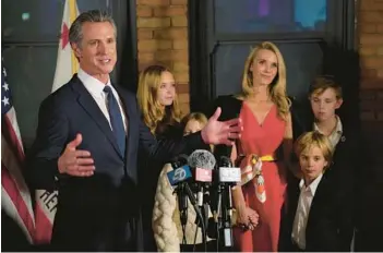  ?? RICH PEDRONCELL­I/AP ?? California Gov. Gavin Newsom, accompanie­d by his family, speaks after winning a second term in office on Tuesday in Sacramento. California voters overwhelmi­ngly decided to add abortion rights to the state constituti­on.