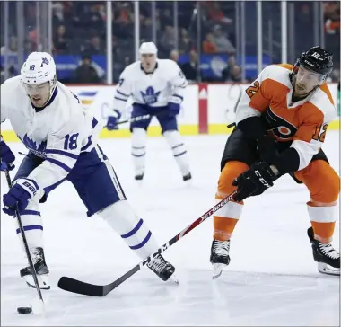  ?? MATT SLOCUM – THE ASSOCIATED PRESS ?? Michael Raffl, right, skates in a Dec. 3game against the Toronto Maple Leafs and defends against Andreas Johnsson. Raffl would break his right pinky later in the game, which the Flyers would win in a blowout.