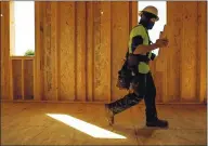  ?? RANDY VAZQUEZ — STAFF PHOTOGRAPH­ER ?? Carpenter Alex Barragan walks past window openings at a home under constructi­on in San Jose earlier this month.