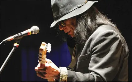  ?? ASSOCIATED PRESS ?? Singer-songwriter Sixto Rodriguez performs at the Beacon Theatre in New York on April 7, 2013. Rodriguez, who became the subject of the Oscar-winning documentar­y “Searching for Sugar Man,” has died. He was 81.