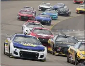  ?? MARK HUMPHREY — THE ASSOCIATED PRESS ?? Driver Chase Elliott, left, takes the high line around a turn during his victory in Sunday’s NASCAR Cup Ally 400.