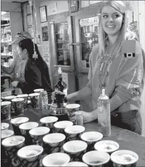  ?? Herald photos by Tim Kalinowski ?? Jasmine Dahl serves up the Irish coffee at the Grange Hotel Bar in Carmangay during the village's St. Patrick Day celebratio­n on Saturday.