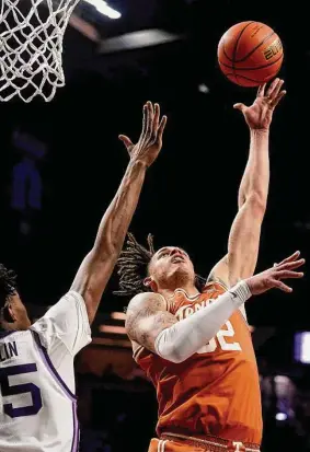  ?? Charlie Riedel/Associated Press ?? Texas forward Christian Bishop shoots over Kansas State forward Nae’Qwan Tomlin. Bishop scored 14 points and grabbed six rebounds.