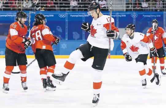  ?? NATHAN DENETTE/THE CANADIAN PRESS ?? Lac La Biche, Alta., native Rene Bourque, centre, celebrates one of his two goals in Canada’s 5-1 victory over Switzerlan­d.