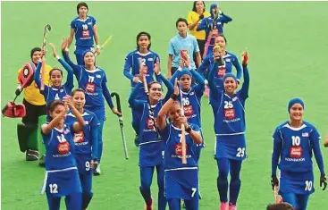  ??  ?? Winners again: The Malaysian women hockey team celebratin­g after beating Russia 3-0 in a Group B match in the World Hockey League Second Round at the Major Dhyan Chand National Stadium in New Delhi yesterday.