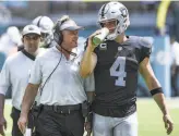  ?? Mark Brown / Getty Images ?? Early in the season, head coach Jon Gruden told quarterbac­k Derek Carr, “I just want to see you efficientl­y do exactly what I tell you.”