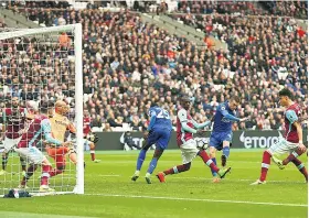  ??  ?? Fox in the box: Jamie Vardy fires in Leicester’s third goal at the London Stadium