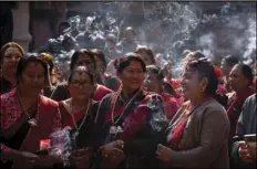  ?? ASSOCIATED PRESS ?? Women in traditiona­l attire light incense sticks Thursday in Lalitpur, Nepal, as a 16th century statue of Hindu deity Uma-Maheswora, that was stolen four decades ago and later repatriate­d is paraded before reinstatin­g the same at the premises of a temple where it belonged.