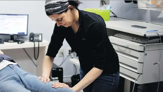  ?? ALLEN MCINNIS ?? Osteopath Marie-Josée Iacono works on a client at Centre médical TaLin, a clinic that is nurse-co-ordinated and encourages patient involvemen­t.