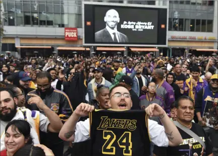  ?? MICHAEL OWEN BAKER - THE ASSOCIATED PRESS ?? Gabriel Rivas, front, chants outside Staples Center at a memorial for Laker legend Kobe Bryant Sunday, Jan. 26, 2020, in Los Angeles. Bryant, the 18-time NBA All-Star who won five championsh­ips and became one of the greatest basketball players of his generation during a 20-year career with the Los Angeles Lakers, died in a helicopter crash Sunday.