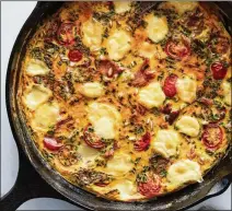  ?? JURKEVICH. JOHNNY MILLER/THE NEW YORK TIMES FOOD STYLED BY REBECCA ?? Cheesy frittata. A heavy skillet is a great multipurpo­se tool, evenly retaining and distributi­ng heat for best results.