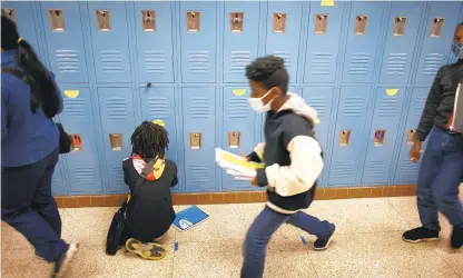  ?? STEPHEN M. KATZ/STAFF ?? Indian River Middle School students keep their distance from one another in the hallways in November.