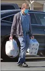  ?? Dan Watson/The Signal ?? A man shops in the Canyon County Plaza wearing a mask Saturday in Canyon Country. SCV residents are required to wear masks in public.