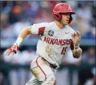  ?? NWA Democrat-Gazette/BEN GOFF ?? Arkansas third baseman Casey Martin runs to first after hitting a double in the fifth inning in a 5-2 victory over Florida on Friday in the College World Series at TD Ameritrade Park in Omaha. Martin went 4 for 5 with 3 runs scored and an RBI as his...