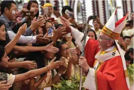  ?? L’Osservator­e Romano / pool photo via AP ?? Pope Francis greets the faithful Thursday as he arrives to celebrate Mass with youths at St. Mary’s Cathedral in Yangon, Myanmar. Later in Bangladesh, he urged world leaders to address the Rohingya Muslim refugee exodus.