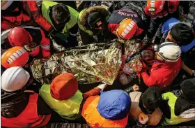  ?? AP PHOTO/EMRAH GUREL ?? Turkish rescue workers carry Eyup Ak, 60, to an ambulance after pulling him out alive from a collapsed building, 104 hours after the earthquake, in Adiyaman, Friday, Feb. 10, 2023.