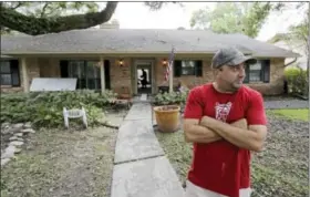  ?? DAVID J. PHILLIP — THE ASSOCIATED PRESS ?? David Cummings talks about surviving flooding from Harvey outside his home Wednesday, Aug. 30, 2017, in Houston. Harvey did not discrimina­te in its destructio­n. It raged through neighborho­ods rich and poor, black and white, upscale and working class....