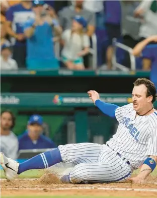  ?? MARTA LAVANDIER/ AP ?? Israel’s Jakob Goldfard slides across home plate to score on a hit by Spencer Horwitz during the eighth inning of Sunday’s World Baseball Classic game against Nicaragua in Miami.