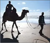  ??  ?? Steve MacNaull on Rgrariya the camel at Lalla Meriem Beach in Casablanca.