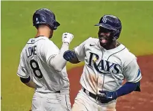  ?? CHRIS O’MEARA/ASSOCIATED PRESS ?? Tampa Bay’s Randy Arozarena gets congratula­tions from teammate Brandon Lowe after Arozarena homered off New York Yankees starter Domingo German. The Rays won, 4-0.