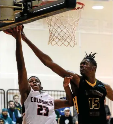  ?? BOB RAINES — DIGITAL FIRST MEDIA ?? Archbishop Wood’s Seth Pinkney fouls Plymouth Whitemarsh’s Ahmin Williams as he tries to block the shot Saturday.