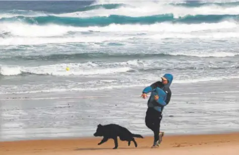  ?? // KIKO DELGADO (EFE) ?? Un hombre jugando con su perro en la playa de Valdoviño, en La Coruña, la semana pasada