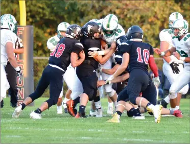  ?? PILOT PHOTO/BEV HARAMIA ?? John Glenn’s Gerardo Coria (54), Chase Howe (16), Nathan Creed (18) and Seth Giese (5) tackle Bremen’s Blake Dingus (10).