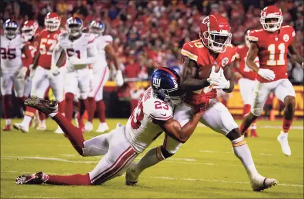  ?? Ed Zurga / Associated Press ?? Chiefs wide receiver Tyreek Hill (10) runs with the ball as Giants cornerback Logan Ryan tries to bring him down on Monday in Kansas City, Mo.