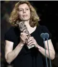  ??  ?? French cinematogr­apher Claire Mathon holds her trophy on stage after she won the Best Cinematogr­apher award for “Portrait de la jeune fille en feu (Portrait of a Lady on Fire)”.