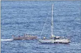  ??  ?? Sailors from the USS Ashland approach the women’s sailboat on Wednesday.