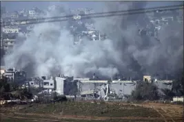  ?? VICTOR R. CAIVANO — THE ASSOCIATED PRESS ?? Smoke rises from an explosion Thursday following an Israeli strike in the Gaza Strip, as seen from southern Israel.