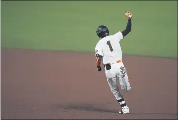  ?? TONY AVELAR — THE ASSOCIATED PRESS ?? The Giants’ Mauricio Dubon raises his armas he runs the bases after hitting a three-run home run against the Rockies during the fifth inning on Wednesday in San Francisco.