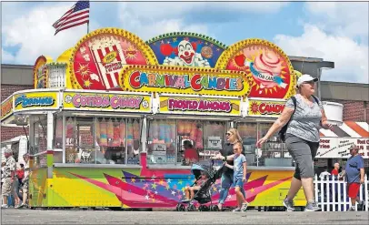  ?? [FRED SQUILLANTE/DISPATCH] ?? Dean Otterbache­r and his brother Kurt serve up cotton candy, elephant ears, fried Oreos and other sweet treats at their three stands at the Ohio State Fair.