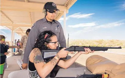  ?? PHOTO COURTESY OF N.M. GAME & FISH ?? Travis Nygren helps a participan­t in the 2016 New Mexico Outdoor Expo with a .22-caliber rifle on one of several ranges staffed by certified instructor­s.