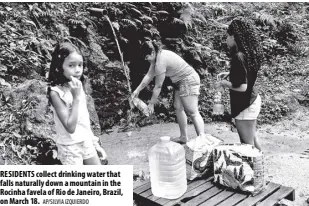  ?? AP/SILVIA IZQUIERDO ?? RESIDENTS collect drinking water that falls naturally down a mountain in the Rocinha favela of Rio de Janeiro, Brazil, on March 18.