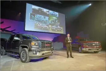  ?? BLOOMBERG NEWS PHOTO BY FABRIZIO COSTANTINI ?? Jeff Luke, executive chief engineer for full- size and mid- size trucks of General Motors, speaks during December’s unveiling of the 2014 GMC Sierra, left, and Chevrolet Silverado in Pontiac, Mich.