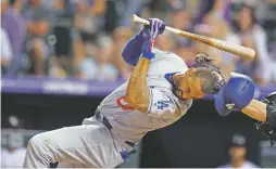  ?? DAVID ZALUBOWSKI/ASSOCIATED PRESS ?? The Dodgers’ Matt Kemp is hit by a pitch thrown by Rockies reliever Scott Oberg in the sixth inning Friday in Denver.