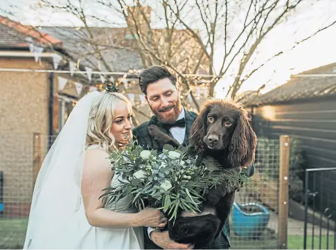  ??  ?? MARRIED AT LAST: Bride Danielle Paton Strang and her husband Richard enjoying their wedding day with dog Bailey.