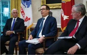  ?? Getty IMages ?? WORKING ON A PLAN: Vice President Mike Pence, left, Treasury Secretary Steven Mnuchin, center, and White House chief of staff Mark Meadows join President Trump last week at the White House in Washington, D.C., to discuss a proposed new round of financial stimulus to help the economy during the coronaviru­s pandemic.