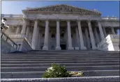  ?? ANDREW HARNIK — THE ASSOCIATED PRESS ?? Flowers lie on the steps to the House Chamber of the Capitol building on Capitol Hill in Washington.