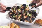  ?? E. JASON WAMBSGANS/CHICAGO TRIBUNE ?? Mussels can be cooked in many ways but this version keeps it simple with tomatoes, white wine, garlic and red pepper flakes for a little heat.