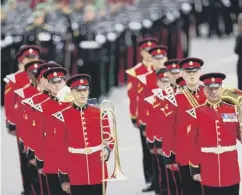  ?? ?? Members of a military marching band walking down Horse Guards Avenue.