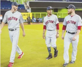  ?? GETTY IMAGES PHOTO ?? NO DAY AT THE BEACH: Craig Kimbrel (right) strolls through the outfield at Marlins Park yesterday with Red Sox teammates and fellow American League All-Stars Chris Sale (left) and Mookie Betts