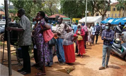  ?? Photograph: Xinhua/REX/ Shuttersto­ck ?? People queueing outside a health centre to receive the Covid-19 vaccine in Kampala, Uganda, in August 2021.