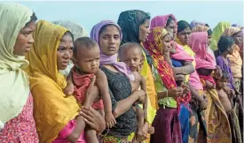  ?? (AFP) ?? Women and children at a makeshift camp in Rakhine state in Myanmar on November 12