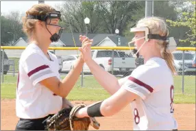  ?? Graham Thomas/Herald-Leader ?? Siloam Springs shortstop Kenlie Noel, left, and third baseman Hannah Evans high five between innings against Pea Ridge in the third-place game of the Lady Panther Invitation­al on Saturday at La-Z-Boy Softball Park.